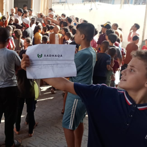 Children in Gaza holding Sadhaqa Logo Banner