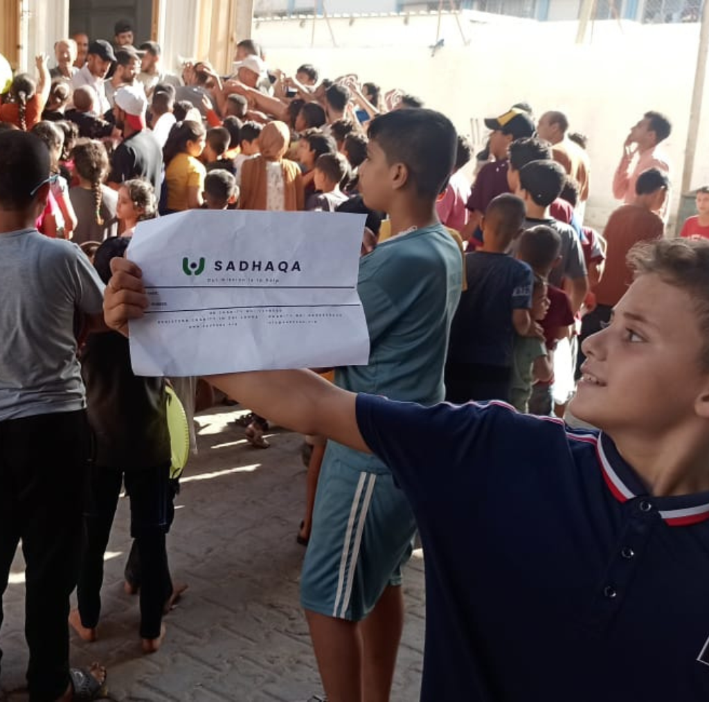 Children in Gaza holding Sadhaqa Logo Banner